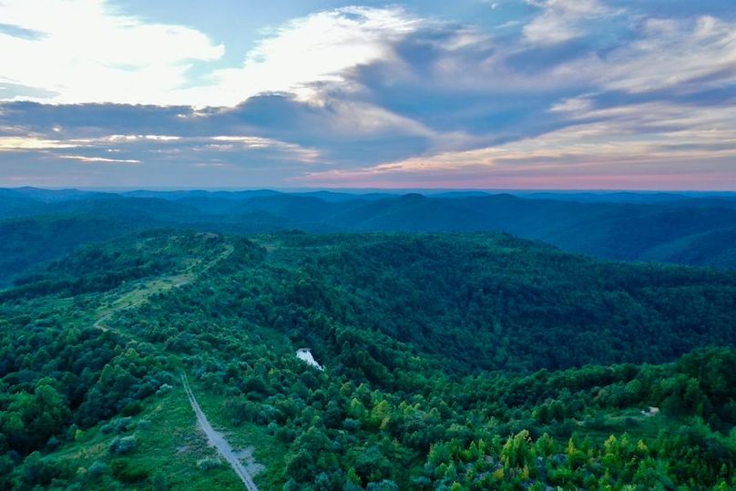 Aerial view of the Cumberland Plateau at dusk — ridges stretching to the horizon, the landscape that becomes the city